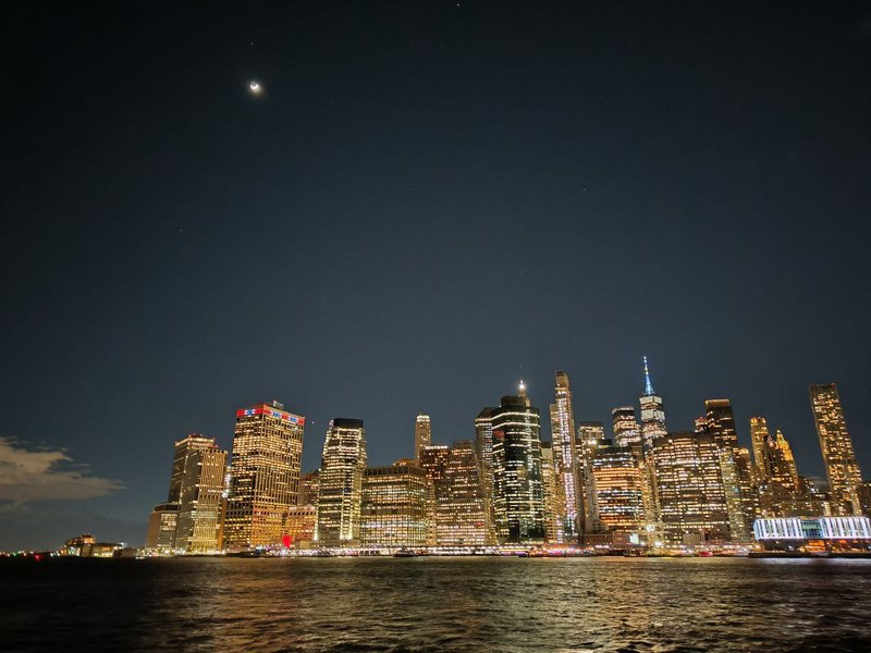 Skyline of Manhattan at night as seen from Brooklyn Bridge Park. The Manhattan skyline at night time