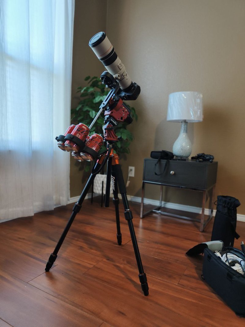 Test assembling my eclipse photography setup. Note the 3D printed soda can holder acting as a counterweight. My eclipse photography gear in the Airbnb living room